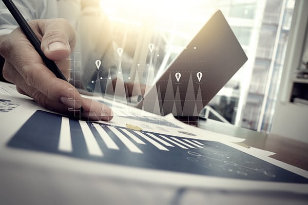 business documents on office table with smart phone and digital tablet and graph financial with social network diagram and man working in the background-1 business documents on office table with smart phone and digital tablet and graph financial with social network diagram and man working in the background-1